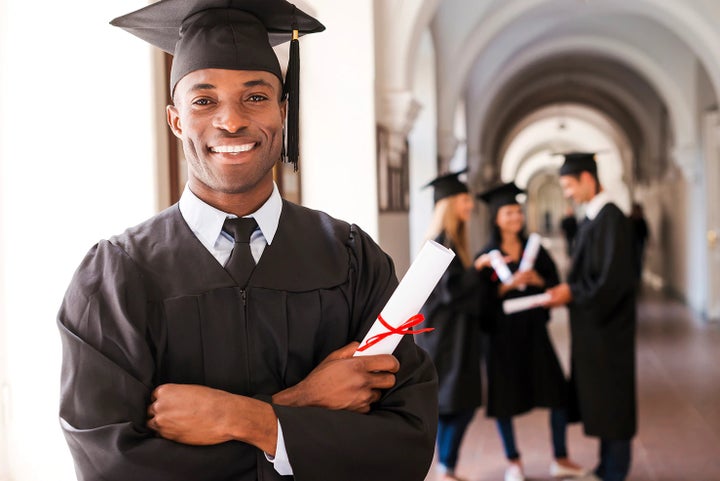 college graduate holding his diploma | Thelen Subaru in Bay City MI