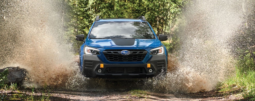 A 2023 Outback Wilderness driving on a muddy trail. | Thelen Subaru in Bay City MI